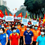 **A vibrant demonstration in Hanoi for climate action, featuring Vietnamese activists holding signs with #ClimateAction and #GoGreen hashtags, captured in a documentary style.** (This focuses on the social media aspect and community awareness).